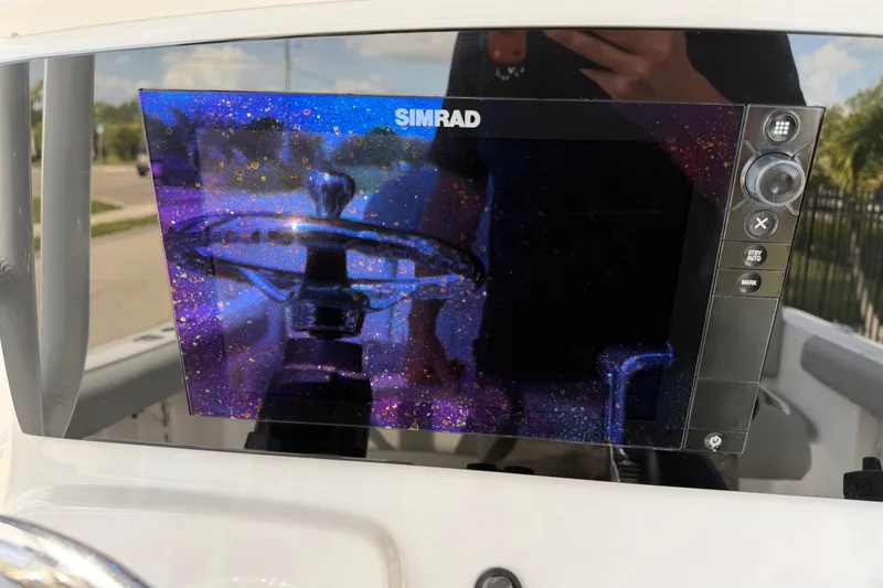 Slide: The Image of Simrad display on 2016 Sportsman Heritage 231 Center Console boat, reflecting steering wheel. - 32