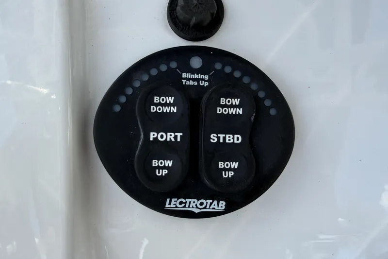Slide: The Image of Control panel for trim tabs on a 2016 Sportsman Heritage 231 Center Console boat. - 33