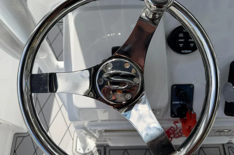Slide: The Image of Steering wheel of 2016 Sportsman Heritage 231 Center Console boat, featuring chrome finish. - 36