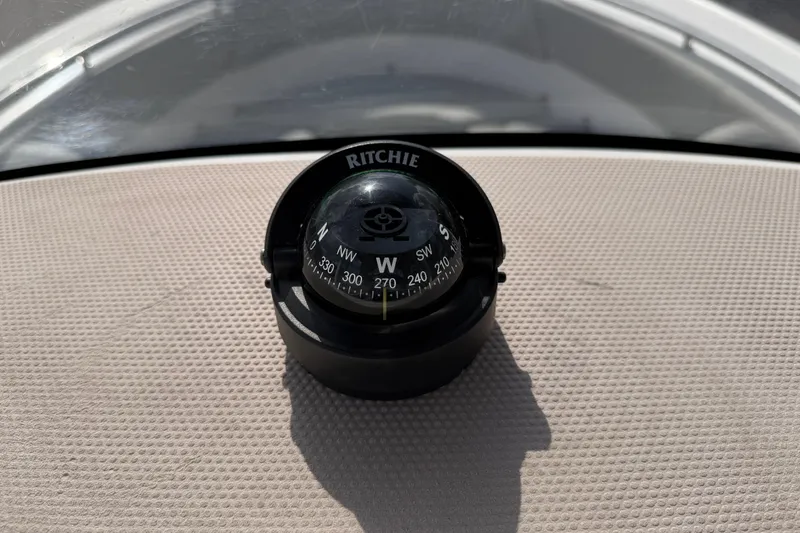 Slide: The Image of Compass on 2016 Sportsman Heritage 231 Center Console boat dashboard. - 37