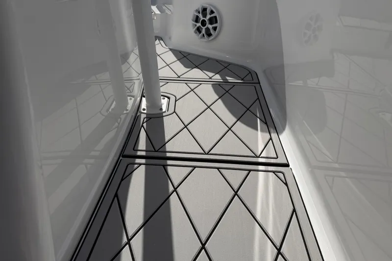 Slide: The Image of 2016 Sportsman Heritage 231 Center Console boat deck with geometric pattern flooring. - 42