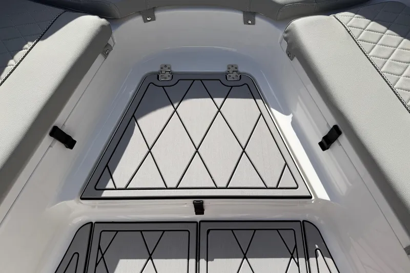 Slide: The Image of 2016 Sportsman Heritage 231 Center Console boat interior with diamond-patterned seating and storage. - 46