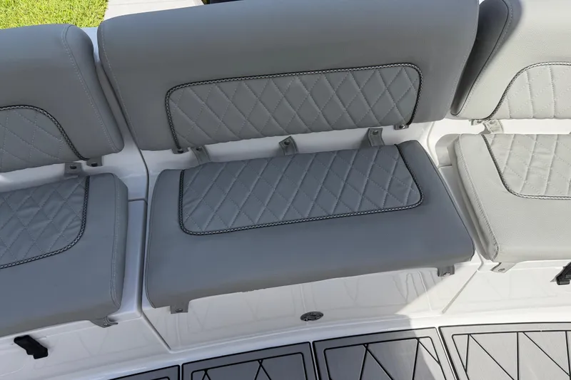 Slide: The Image of Gray cushioned seating on 2016 Sportsman Heritage 231 Center Console boat, featuring diamond stitching. - 57