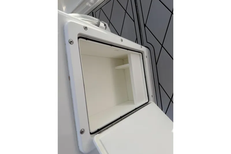 Slide: The Image of Open storage compartment on 2016 Sportsman Heritage 231 Center Console boat. - 67