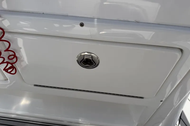 Slide: The Image of 2016 Sportsman Heritage 231 Center Console storage compartment with latch and red coiled cord. - 68