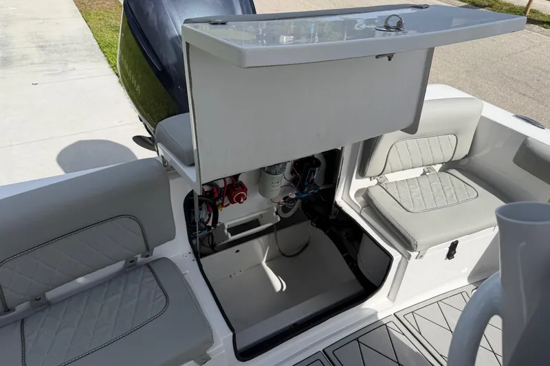 Slide: The Image of 2016 Sportsman Heritage 231 Center Console boat interior with open storage compartment. - 72