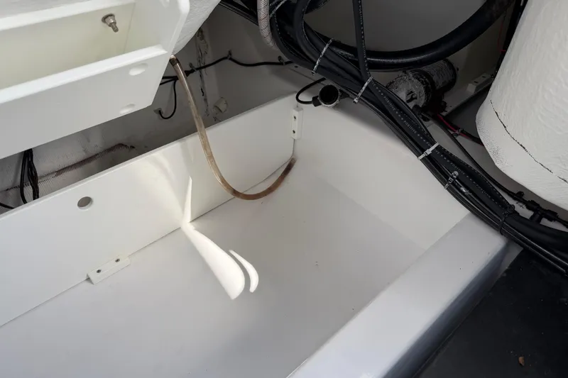 Slide: The Image of Interior view of a 2016 Sportsman Heritage 231 Center Console boat, showcasing wiring and compartments. - 73