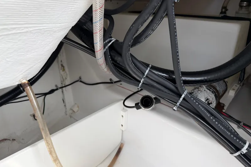 Slide: The Image of Wiring and hoses inside a 2016 Sportsman Heritage 231 Center Console boat. - 78