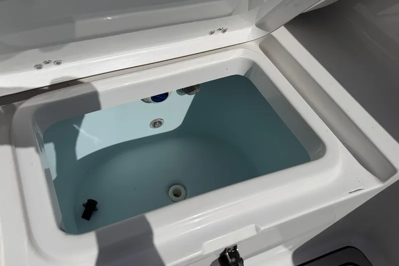Slide: The Image of Livewell compartment on a 2016 Sportsman Heritage 231 Center Console boat. - 83