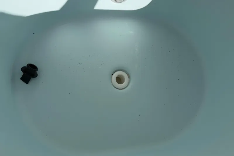 Slide: The Image of 2016 Sportsman Heritage 231 Center Console boat drain plug detail. - 85