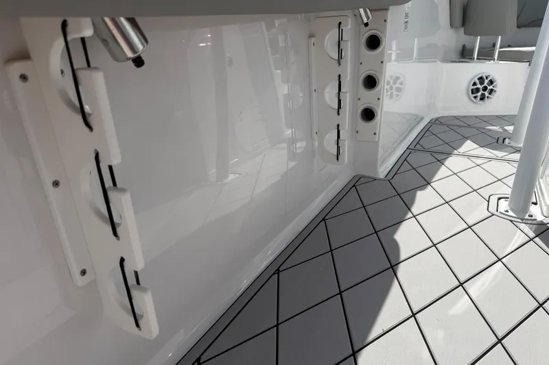 Slide: The Image of 2016 Sportsman Heritage 231 Center Console boat interior with rod holders and non-slip flooring. - 86