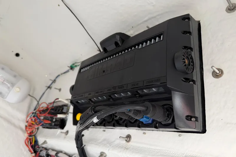 Slide: The Image of Electrical panel inside 2016 Sportsman Heritage 231 Center Console boat, showcasing wiring and connections. - 98