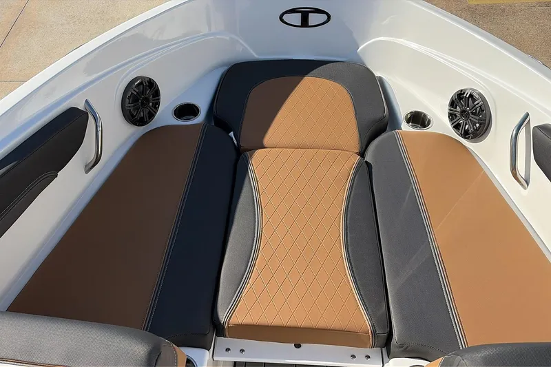 Slide: The Image of 2025 Tahoe 210 Si boat interior with brown and black cushioned seating. - 13