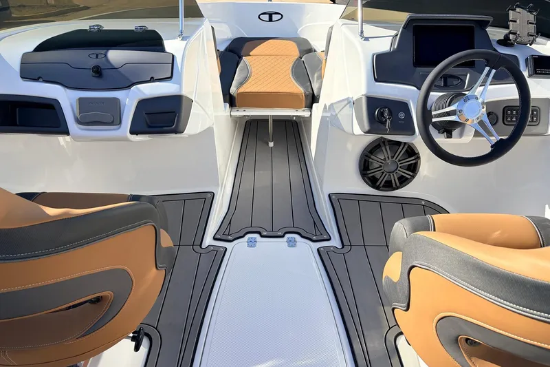 Slide: The Image of Interior of 2025 Tahoe 210 Si boat with modern dashboard and tan seating. - 23