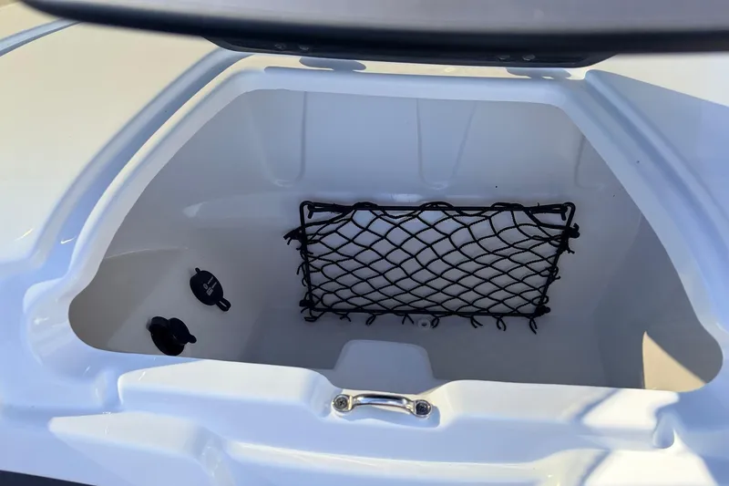 Slide: The Image of 2025 Tahoe 210 Si boat storage compartment with netting and secure latches. - 26