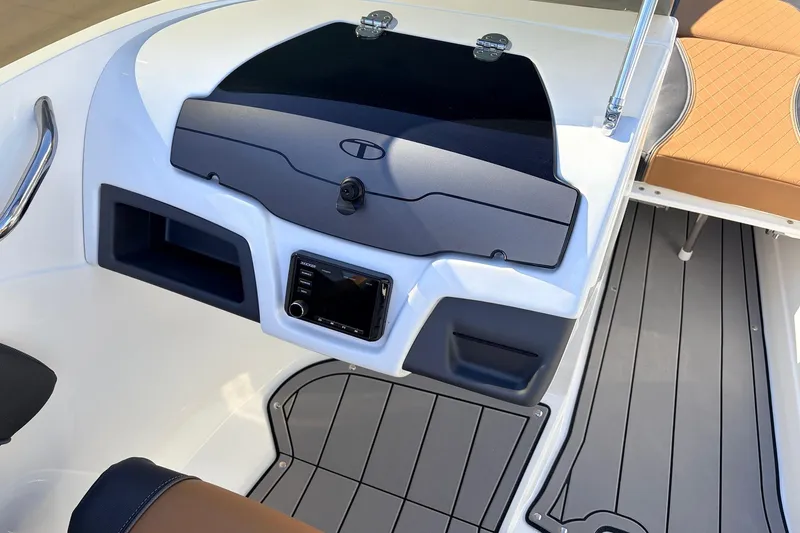 Slide: The Image of 2025 Tahoe 210 Si boat dashboard with modern controls and seating. - 27