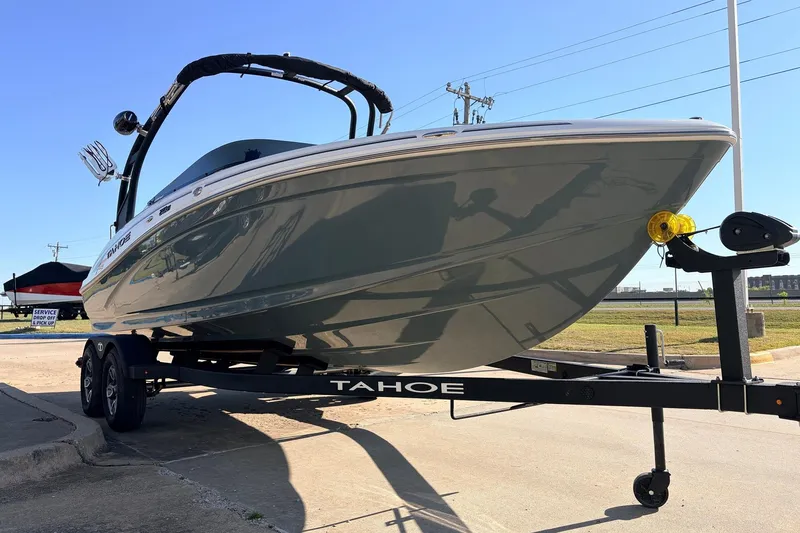 Slide: The Image of 2025 Tahoe 210 Si boat on trailer, parked outdoors under clear sky. - 3