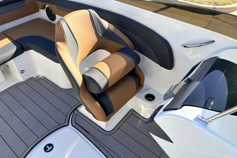 Slide: The Image of 2025 Tahoe 210 Si boat interior with tan and black seating, modern design. - 30