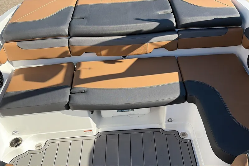 Slide: The Image of 2025 Tahoe 210 Si boat interior with tan and gray cushioned seating. - 41
