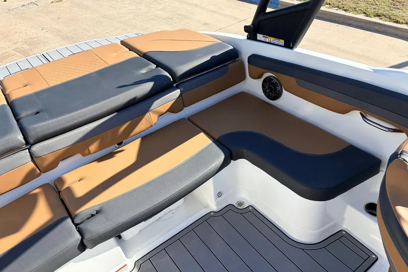 Slide: The Image of 2025 Tahoe 210 Si boat interior with tan and black seating, featuring modern design and speaker system. - 43