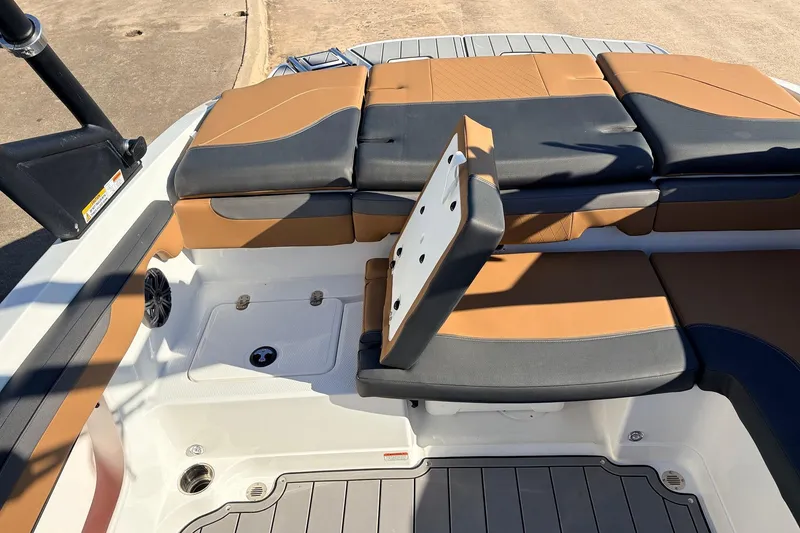 Slide: The Image of 2025 Tahoe 210 Si boat interior with tan and black seating, showcasing modern design. - 47