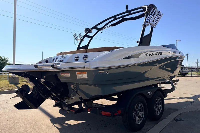 Slide: The Image of 2025 Tahoe 210 Si boat on trailer, sleek design, outdoor setting. - 5