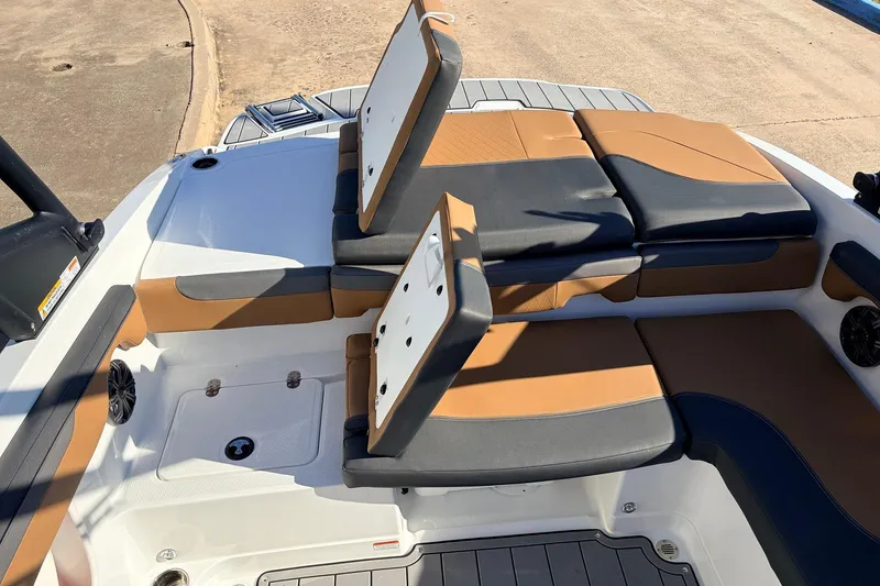 Slide: The Image of 2025 Tahoe 210 Si boat interior with tan and black seating, showcasing modern design. - 50