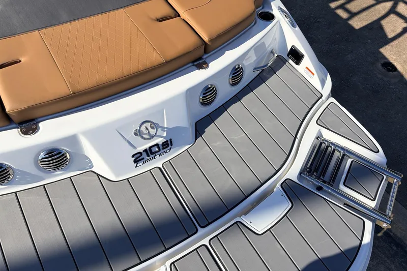 Slide: The Image of 2025 Tahoe 210 Si boat with tan seating and sleek gray deck design. - 59