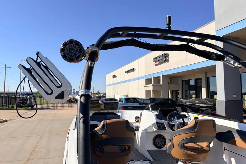Slide: The Image of 2025 Tahoe 210 Si boat with sleek interior and modern design at dealership. - 60