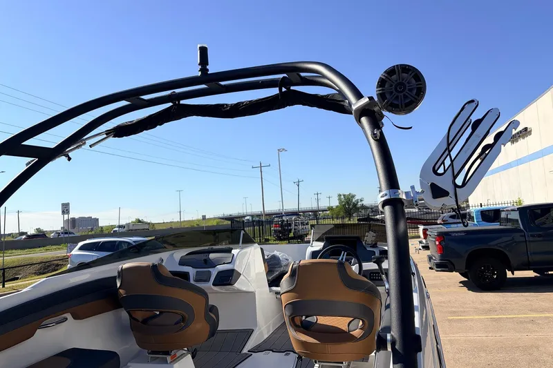 Slide: The Image of 2025 Tahoe 210 Si boat interior with sleek design and modern features, parked outdoors. - 61