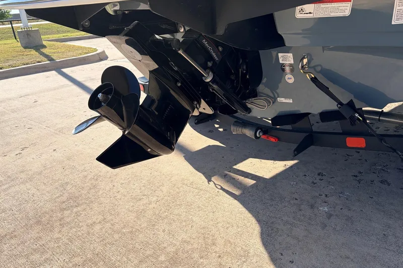 Slide: The Image of 2025 Tahoe 210 Si boat engine and propeller on a trailer in sunlight. - 9