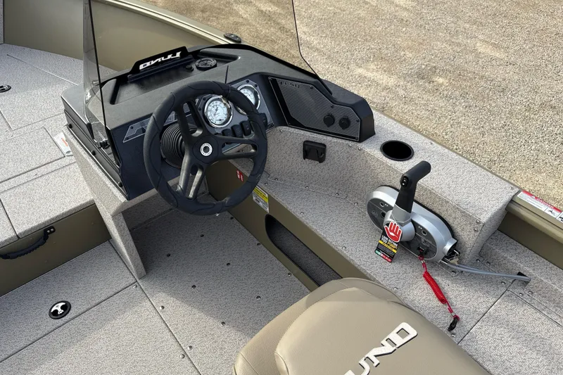 Slide: The Image of 2026 Lund 2075 Alaskan SS boat interior with steering wheel and control panel. - 11