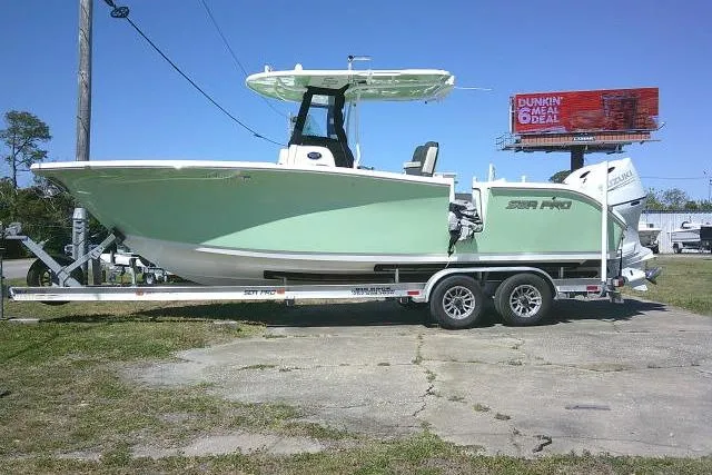 The Image of 2022 Sea Pro 259 Center Console boat on trailer, parked outdoors. - 0