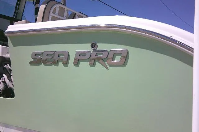 Slide: The Image of 2022 Sea Pro 259 Center Console boat with logo on green hull. - 11