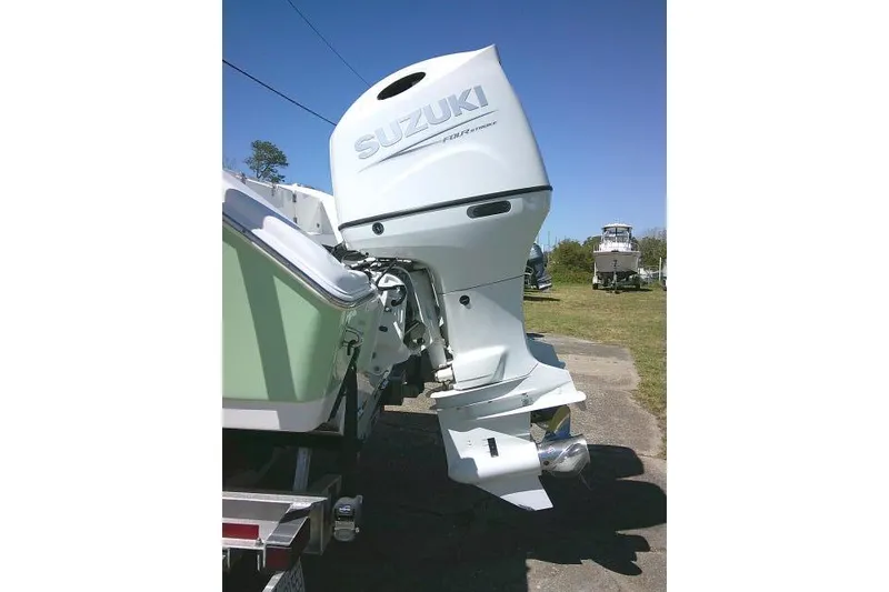 Slide: The Image of 2022 Sea Pro 259 Center Console with Suzuki outboard motor, parked outdoors. - 12