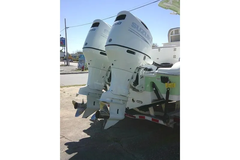 Slide: The Image of Twin Suzuki outboard motors on a 2022 Sea Pro 259 Center Console boat. - 13