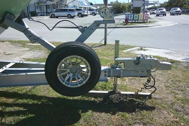 Slide: The Image of Trailer hitch of a 2022 Sea Pro 259 Center Console boat on grass. - 18