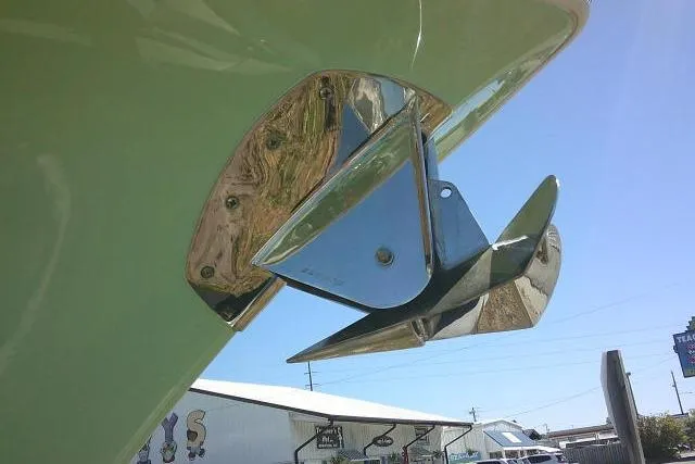 Slide: The Image of Chrome anchor detail on 2022 Sea Pro 259 Center Console boat under clear blue sky. - 19