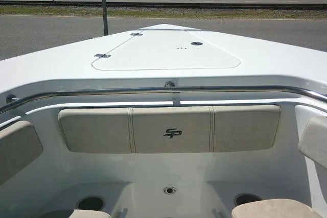 Slide: The Image of 2022 Sea Pro 259 Center Console boat interior with cushioned seating and storage compartment. - 24