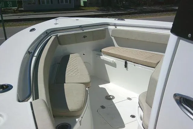 Slide: The Image of 2022 Sea Pro 259 Center Console boat interior with cushioned seating and storage compartments. - 26