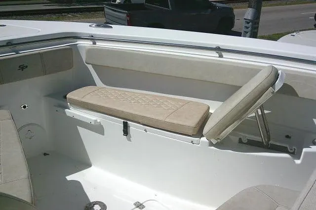 Slide: The Image of 2022 Sea Pro 259 Center Console boat interior with cushioned seating and storage. - 27