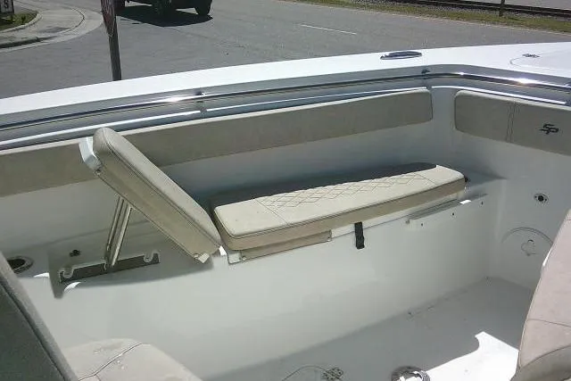 Slide: The Image of 2022 Sea Pro 259 Center Console boat interior with cushioned seating and storage. - 29