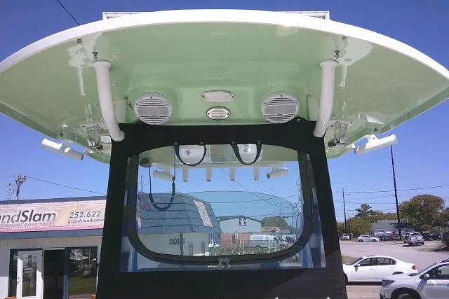 Slide: The Image of 2022 Sea Pro 259 Center Console boat with T-top and speakers, parked outdoors. - 31