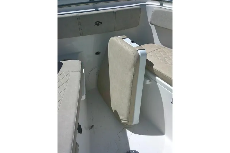 Slide: The Image of 2022 Sea Pro 259 Center Console boat interior with beige cushioned seating. - 32