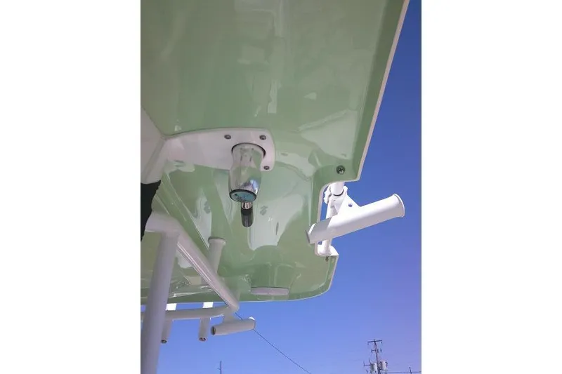 Slide: The Image of 2022 Sea Pro 259 Center Console boat underside with rod holders against blue sky. - 33