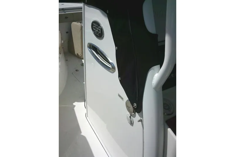 Slide: The Image of 2022 Sea Pro 259 Center Console boat interior with sleek white finish and chrome accents. - 34