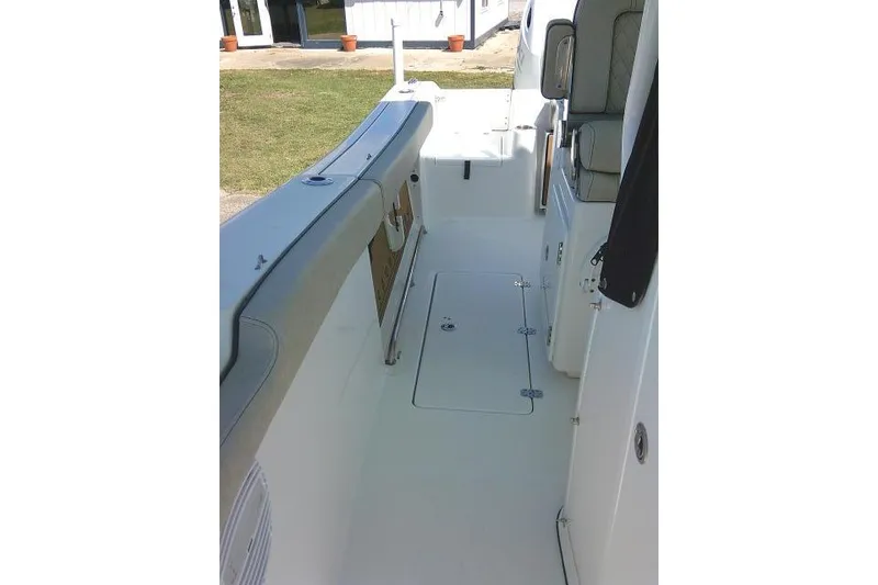 Slide: The Image of 2022 Sea Pro 259 Center Console boat interior with seating and storage compartments. - 36