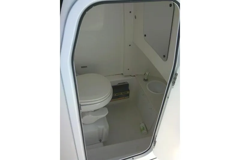 Slide: The Image of Interior view of 2022 Sea Pro 259 Center Console boat's compact bathroom. - 39