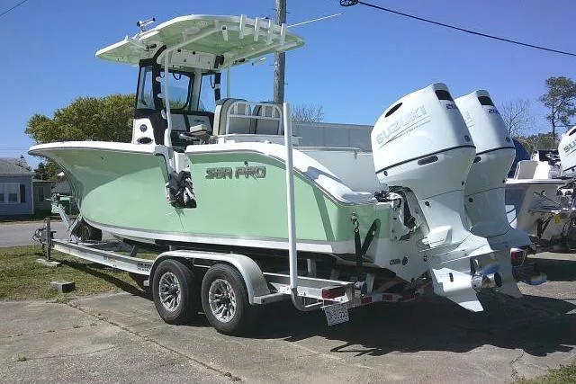 Slide: The Image of 2022 Sea Pro 259 Center Console boat on trailer with dual outboard engines. - 4