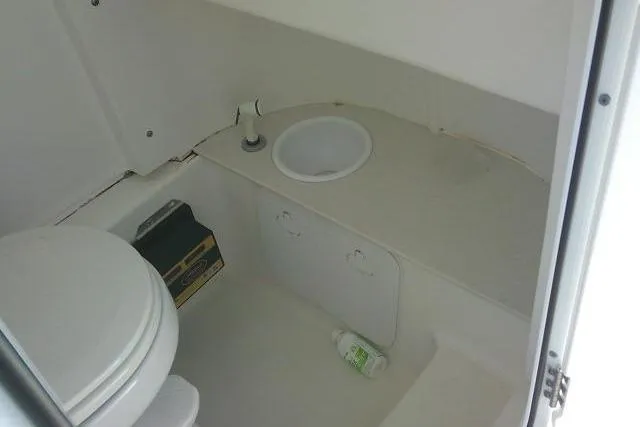 Slide: The Image of Interior of 2022 Sea Pro 259 Center Console boat bathroom with toilet and sink. - 41